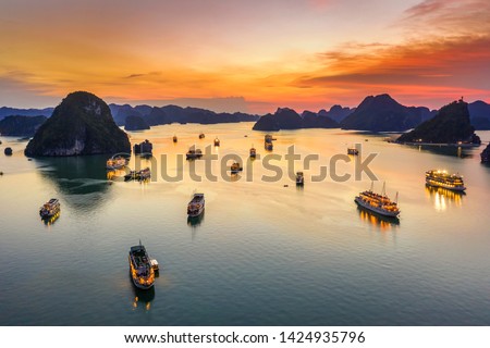 Aerial view of sunset and dawn near rock island, Halong Bay, Vietnam, Southeast Asia. UNESCO World Heritage Site. Junk boat cruise to Ha Long Bay. Popular landmark, famous destination of Vietnam