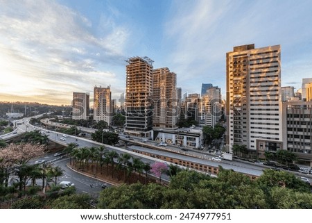 Aerial view of sunset  in Sao Paulo city, Brazil. Beggining the night in metropolis, Skyline, cars and traffic on the road