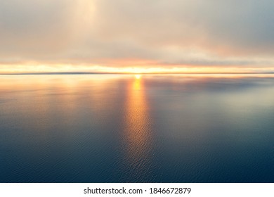 Aerial View Of A Sunset Sky Background. Aerial Dramatic Gold Sunset Sky With Evening Sky Clouds Over The Sea. Sky Landscape. Aerial Photography.