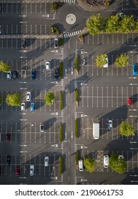 Aerial view of a supermarket carpark with parked cars and empty spaces