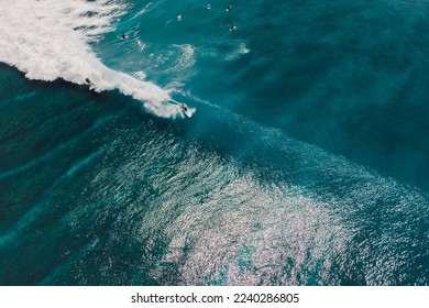 Aerial view with surfing on ideal wave. Perfect waves with surfers in blue ocean