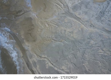 Aerial view of surrealistic industrial place. Dry surface. Desertic landscape. Human impact on the environment. View from above. Abstract industrial background. Photo made by drone.