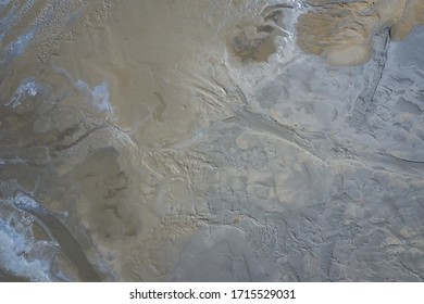 Aerial view of surrealistic industrial place. Dry surface. Desertic landscape. Human impact on the environment. View from above. Abstract industrial background. Photo made by drone.