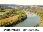 The aerial view of the Susquehanna River surrounded by striking color of fall foliage near Wyalusing, Pennsylvania, U.S.A