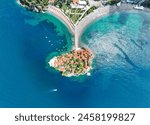 Aerial view of Sveti Stefan island in Budva, Montenegro. It consists of a small island now connected to the mainland by a narrow tombolo and the mainland part, where most of the residents live.