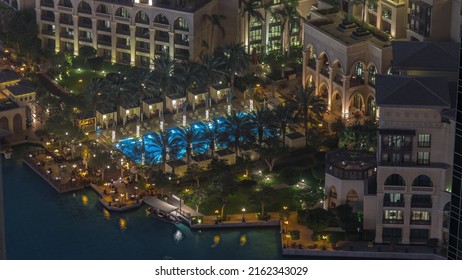 Aerial View Of Swimming Pool Relaxing Zone In Old Town Island From Above Night Timelapse. Dubai Downtown With Illuminated Traditional Buildings