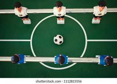 Aerial View Of Table Football Kicker With White And Blue Miniature Figurines Starting A New Game