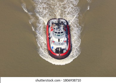 An Aerial View Taken From A Helicopter Of A Tug Boat Pilot Vessel In The Thames Estuary. The Red And White Ship Guides Shipping On The Outskirts Of London. A Single Boat Seen From Above.