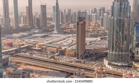 Aerial view of tallest towers in Dubai Downtown skyline and shopping mall timelapse. Financial district and business area in smart urban city. Skyscraper and high-rise buildings