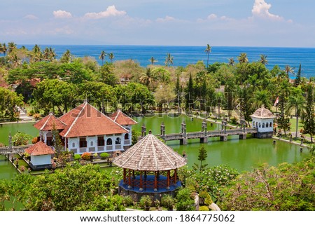 Aerial view of Taman Ujung water palace near Alampura in Karangasem on Bali Island. Ancient palace of Balinese royal family with water pools and tropical landscape park. Indonesian art and culture.