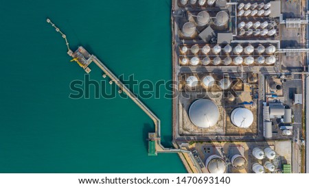 Aerial view of tank farm oil and gas terminal with lots of fuel petroleum chemical natural gas storage tank and petrochemical in the harbour, Business power and energy industrial tank storage .