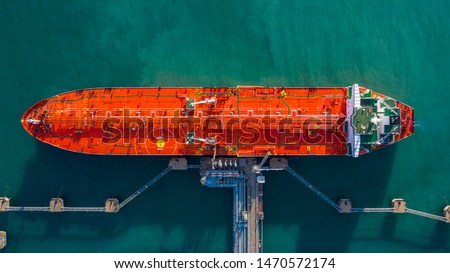 Aerial view tanker ship vessel unloading at port, Business import export oil and gas petrochemical with tanker ship transportation oil from dock refinery, Loading arm oil and gas offshore platforms.