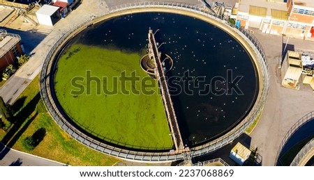 Aerial view of the tanks of a sewage and water treatment plant enabling the discharge and re-use of waste water. It's a sustainable water recycling with treatment plant.