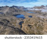 Aerial view to Tasiilaq fjord in Greenland, foggy sky landscape