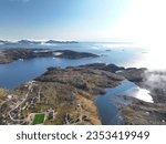 Aerial view to Tasiilaq fjord in Greenland, foggy sky landscape