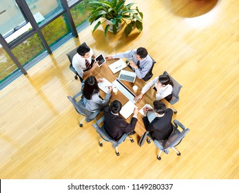 Aerial View Of A Team Of Asian Business Men And Women Meeting In Modern Office.