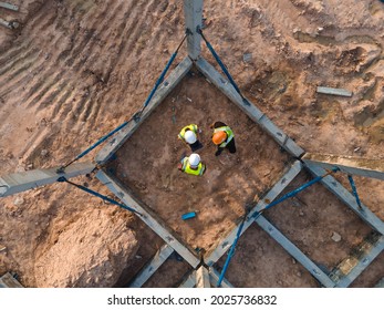 Aerial View Team Engineer Consultant Discussion Meeting Follow Up Progress Install Structure Prefabricated Concrete Ground Beam Assembly With Pillar And Formwork Support In Construction Site Work.