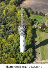 Aerial View Of A Television Transmission Tower Between Tilburg En Loon Op Zand, The Netherlands Surrounded By Green Woods. 