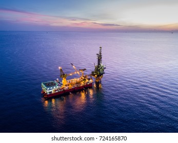 Aerial View of Tender Drilling Oil Rig (Barge Oil Rig) in The Middle of The Ocean at Sunrise Time