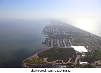 Aerial View Of  The Texas Gulf Coast, Galveston Island, United States Of America. Haze Due To Warm Weather Conditions. Two Powered Paragliders, Paramotors, Real Estate And Travel Landscape Panorama.
