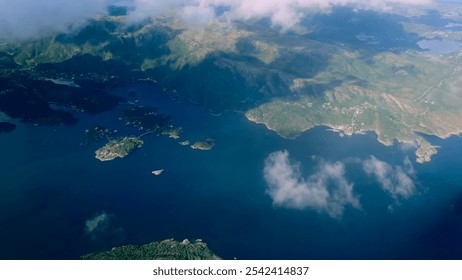 Aerial view through the clouds to the sea bay with coastal hills. Top view from the clouds to the Norwegian fjords - Powered by Shutterstock