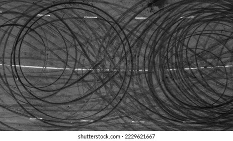 Aerial view tire track mark on asphalt tarmac road race track texture and background, Abstract background black tire track skid on asphalt road, Tire mark skid mark on asphalt road. - Shutterstock ID 2229621667