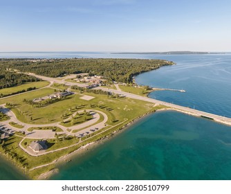 Aerial view of the toll booths north of the Mackinac Bridge with the road side park and beach on a sunny summer afternoonn - Shutterstock ID 2280510799