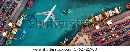 Aerial view and top view cargo plane flying above ship port in the export and import business and logistics international goods. Shipping cargo to harbor by crane