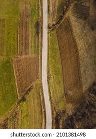 Aerial view top down from above on the country road in mountain range in between fields grass and trees around - nature travel concept drone photo on Stara Planina Old Mountain in Europe Serbia