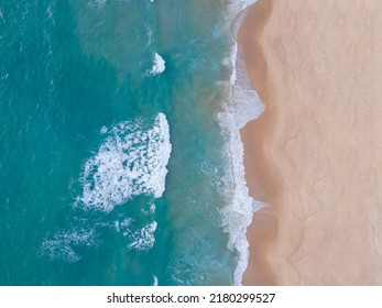 Aerial view Top-down Beach sand and seawater wave in sunset time. Tropical Sea Andaman Sea