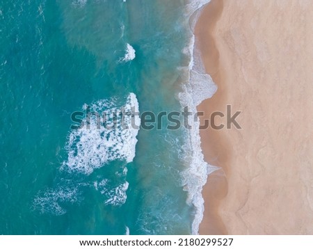 Aerial view Top-down Beach sand and seawater wave in sunset time. Tropical Sea Andaman Sea