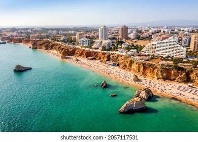 Aerial view of touristic Portimao with wide sandy Rocha beach, Algarve, Portugal