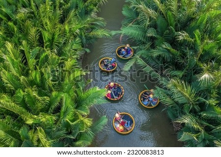 Aerial view, tourists from Thailand, Korea, America and Japan are relax and experiencing a basket boat tour at the coconut water ( mangrove palm ) forest in Cam Thanh village, Hoi An,Quang Nam,Vietnam