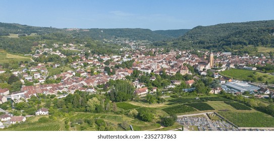 Aerial view of the town of Arbois in summer, located in the Jura department in the Bourgogne Franche Comté region. This town nestled in the heart of the Jura vineyards is also the capital of Jura wine - Shutterstock ID 2352737863