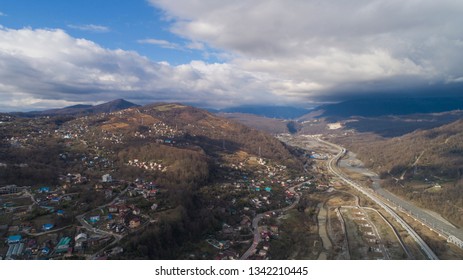 Aerial View Of A Town With River In Mountains. Sochi, Russia. Highway To Krasnaya Polyana 