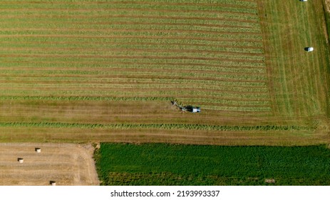 Aerial View Of Tractor Mowing Green Field