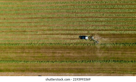 Aerial View Of Tractor Mowing Green Field