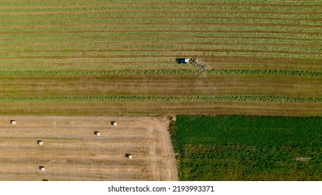 Aerial View Of Tractor Mowing Green Field