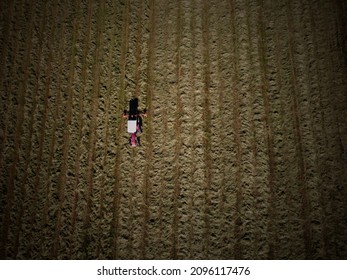 An Aerial View As A Tractor Mows Hay On A Small Farm In Central Maine