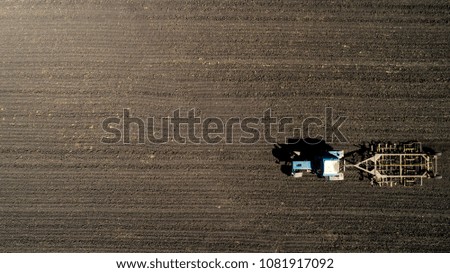 Similar – Combine harvester harvests a grain field in the evening light from the air