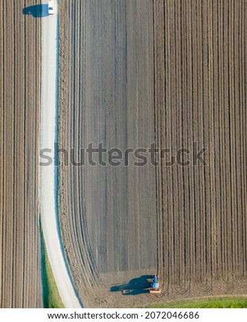 Similar – Image, Stock Photo Combine harvester harvests grain field in the evening light from the air