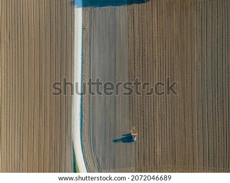 Similar – Erntemaschine, die im Feld arbeitet. Kombinierte Maschine