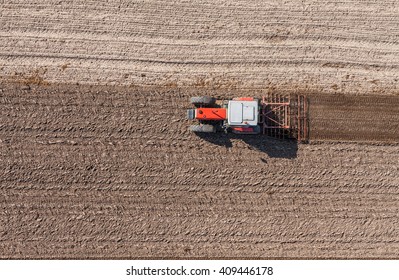 Aerial View Of The Tractor Working On The Harvest Field  In Poland