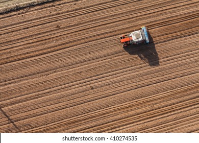 Aerial View Of The Tractor Working On The Harvest Field  In Poland