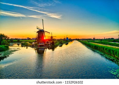 Aerial view of traditional windmills at sunset in Kinderdijk, The Netherlands. This system of 19 windmills was built around 1740 and is a UNESCO heritage site.