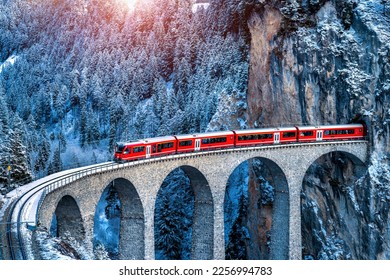 Aerial view of Train passing through famous mountain in Filisur, Switzerland.   train express in Swiss Alps snow winter scenery. 