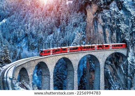 Aerial view of Train passing through famous mountain in Filisur, Switzerland.   train express in Swiss Alps snow winter scenery.  商業照片 © 