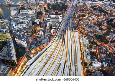 Aerial View Of Train Tracks Entering London Bridge Illuminated At Dusk 