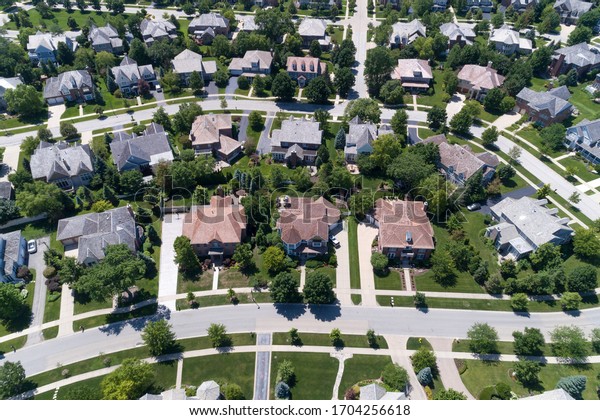 Aerial view of a tree-lined neighborhood in a\
Chicago suburban city in\
summer.