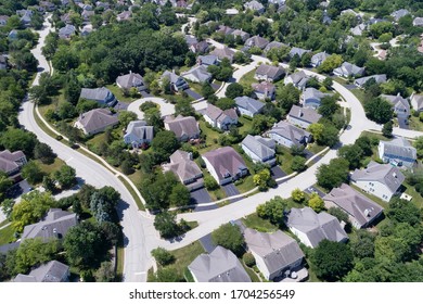Aerial view of a tree-lined, suburban neighborhood with cul-de-sac in summer.